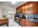 Kitchen featuring wooden cabinets, granite countertops, stainless steel appliances, and tile backsplash at 11407 3Rd N St # 1, St Petersburg, FL 33716