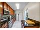 Well-lit kitchen with stainless steel appliances, granite countertops, and white tile flooring at 11407 3Rd N St # 1, St Petersburg, FL 33716