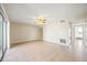 Expansive living room with tile flooring, ceiling fan, and sliding glass doors for natural light at 11407 3Rd N St # 1, St Petersburg, FL 33716