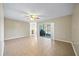 Spacious living room with tile flooring, ceiling fan and sliding glass doors leading to an outdoor area at 11407 3Rd N St # 1, St Petersburg, FL 33716