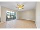 Bright living room featuring tile flooring, ceiling fan, and sliding glass doors that open to a patio area at 11407 3Rd N St # 1, St Petersburg, FL 33716