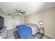 Main bedroom with ceiling fan, patterned rug, and a full-size bed under a large window at 11407 3Rd N St # 1, St Petersburg, FL 33716