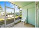 Screened-in patio with a white plastic chair and a view of the community buildings at 11407 3Rd N St # 1, St Petersburg, FL 33716