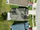 Aerial view of a well-maintained house with a driveway, lawn, and landscaped surroundings at 11517 Weston Course Loop, Riverview, FL 33579