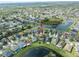 Aerial view of a house and its surrounding properties, with a lake in the distance at 11517 Weston Course Loop, Riverview, FL 33579