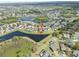 Aerial view of a house with lake view and a well-maintained neighborhood at 11517 Weston Course Loop, Riverview, FL 33579