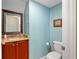 Powder room with a granite vanity, wood cabinets, and a decorative mirror at 11517 Weston Course Loop, Riverview, FL 33579