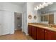 Main bathroom features double sinks, granite countertops, tile floor, and walk-in shower at 11517 Weston Course Loop, Riverview, FL 33579