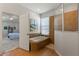 Main bathroom features a soaking tub, walk-in shower, and access to the main bedroom at 11517 Weston Course Loop, Riverview, FL 33579