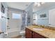 Bathroom with blue walls and a bathtub with shower at 11517 Weston Course Loop, Riverview, FL 33579