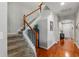 Bright foyer features hardwood floors, stairway with wood railing, and white trim at 11517 Weston Course Loop, Riverview, FL 33579