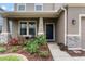 Inviting front entrance with well-kept garden, stone accents, and a cozy, covered porch at 11517 Weston Course Loop, Riverview, FL 33579