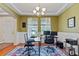 Bright home office featuring hardwood floors, wainscoting, a tray ceiling, and natural light at 11517 Weston Course Loop, Riverview, FL 33579
