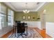 Comfortable home office with hardwood floors, wainscoting, and a view to the front yard at 11517 Weston Course Loop, Riverview, FL 33579
