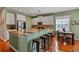 Modern kitchen with white cabinets, stainless steel appliances, breakfast bar, and adjacent dining area at 11517 Weston Course Loop, Riverview, FL 33579