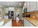 Well-equipped kitchen featuring white cabinets, stainless steel appliances, and hardwood floors at 11517 Weston Course Loop, Riverview, FL 33579
