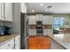 Kitchen features white cabinets, granite countertops, and stainless steel appliances at 11517 Weston Course Loop, Riverview, FL 33579