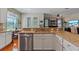 Open concept kitchen with granite countertops and stainless steel dishwasher at 11517 Weston Course Loop, Riverview, FL 33579