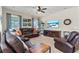 Spacious living room with large, comfortable seating, a ceiling fan and large-screen television at 11517 Weston Course Loop, Riverview, FL 33579
