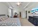 Beautiful main bedroom with ceiling fan, large windows, and adjoining en suite bathroom at 11517 Weston Course Loop, Riverview, FL 33579