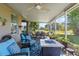Covered patio with comfortable seating, a fire pit, ceiling fan, and a view of the lush backyard at 11517 Weston Course Loop, Riverview, FL 33579