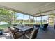 Screened patio with comfortable outdoor seating, ceiling fan, and peaceful lake views at 11517 Weston Course Loop, Riverview, FL 33579