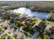 Aerial view of properties showcasing neighborhood with lake and trees at 11720 Winterset Cove Dr, Riverview, FL 33579