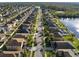 Wide aerial view of residential street with nicely landscaped homes and lake at 11720 Winterset Cove Dr, Riverview, FL 33579