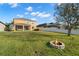 Spacious backyard with a fire pit and lush green lawn, perfect for outdoor activities at 11720 Winterset Cove Dr, Riverview, FL 33579