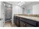 Well-appointed bathroom with double sinks, granite counters, and shower visible in the background at 11720 Winterset Cove Dr, Riverview, FL 33579