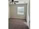 Neutral bedroom featuring a ceiling fan and a large window with water views at 11720 Winterset Cove Dr, Riverview, FL 33579