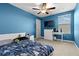 Bright bedroom with a ceiling fan, carpet, and modern blue color scheme at 11720 Winterset Cove Dr, Riverview, FL 33579