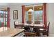 Dining area featuring a wooden table, red curtains and natural light from the windows at 11720 Winterset Cove Dr, Riverview, FL 33579