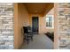 A cozy front porch with stone columns has a table and chairs at 11720 Winterset Cove Dr, Riverview, FL 33579