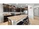 Kitchen with granite countertops, stainless steel appliances, dark cabinets, and island with seating at 11720 Winterset Cove Dr, Riverview, FL 33579
