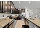 Kitchen with granite countertops, stainless steel appliances, and dark cabinets at 11720 Winterset Cove Dr, Riverview, FL 33579