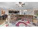 Open-concept living room featuring tile floors and view of the kitchen and stairs at 11720 Winterset Cove Dr, Riverview, FL 33579