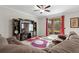 This living room features a large tv, dark-stained entertainment center and a red patterned rug at 11720 Winterset Cove Dr, Riverview, FL 33579