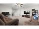 Spacious living room with ceiling fan, neutral carpet, television, comfortable seating, and bonus desk space at 11720 Winterset Cove Dr, Riverview, FL 33579