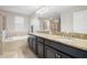 Spa-like bathroom with double sinks, granite counters, and separate shower and tub at 11720 Winterset Cove Dr, Riverview, FL 33579