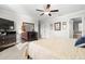 A bright main bedroom with a dresser, art pieces, and access to the main bathroom at 11720 Winterset Cove Dr, Riverview, FL 33579
