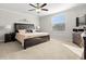 Tranquil main bedroom featuring neutral carpet, king bed, crown molding, fan, and a bright window at 11720 Winterset Cove Dr, Riverview, FL 33579