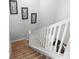 Carpeted staircase with white banister and decorative wall art at 11720 Winterset Cove Dr, Riverview, FL 33579