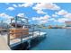 View of the private boat dock featuring a boat lift, perfect for waterfront living and boating enthusiasts at 13707 Lagoon Dr, Hudson, FL 34667