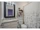 Cozy bathroom with a patterned shower curtain, vanity with a granite countertop, and a decorative shelf at 1516 Glen Alpine Pl, Valrico, FL 33594