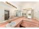 Bathroom featuring a double sink vanity, ample countertop space, and a separate shower area at 1559 Overland Dr, Spring Hill, FL 34608