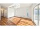 Spacious bedroom with hardwood floors, natural lighting, and access to a private balcony at 1559 Overland Dr, Spring Hill, FL 34608