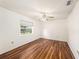 Cozy bedroom with hardwood floors and ample natural light from a large window at 1559 Overland Dr, Spring Hill, FL 34608