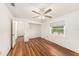 Bright bedroom featuring a ceiling fan, wood floors, and a window offering natural light at 1559 Overland Dr, Spring Hill, FL 34608