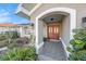 Inviting entryway with a tiled floor, double doors, and manicured landscaping at 1559 Overland Dr, Spring Hill, FL 34608